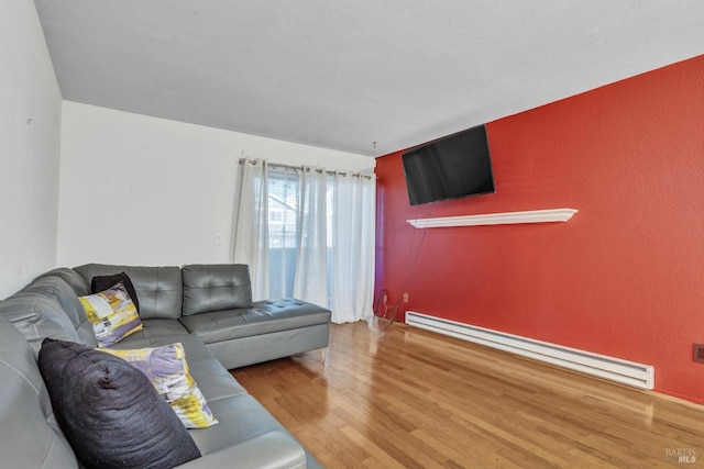 living room with wood-type flooring and a baseboard radiator