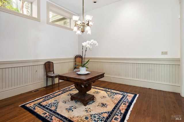 living area featuring an inviting chandelier and dark wood-type flooring