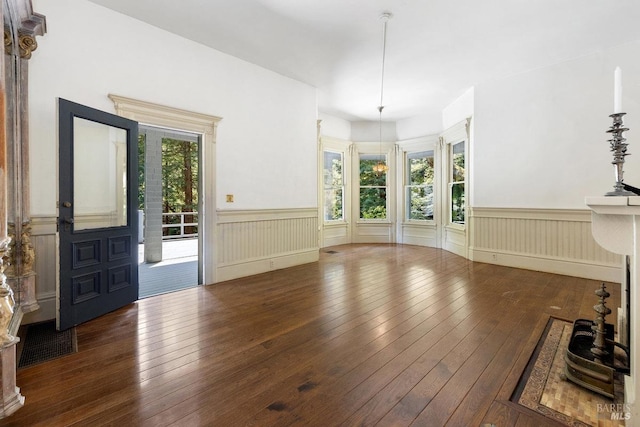 interior space featuring dark wood-type flooring and a notable chandelier