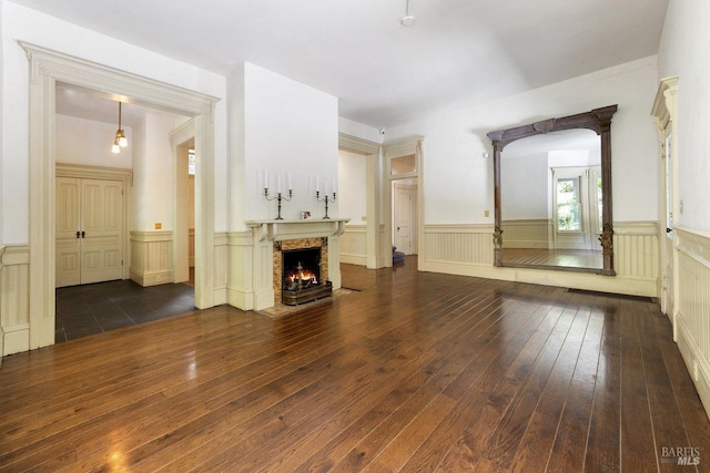 unfurnished living room featuring dark hardwood / wood-style flooring and a fireplace