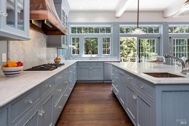 kitchen featuring premium range hood, sink, gray cabinetry, hanging light fixtures, and ornamental molding