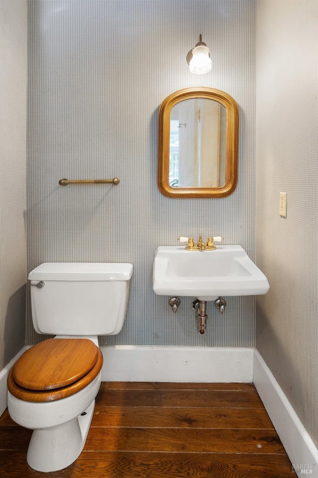 bathroom featuring hardwood / wood-style floors, sink, and toilet