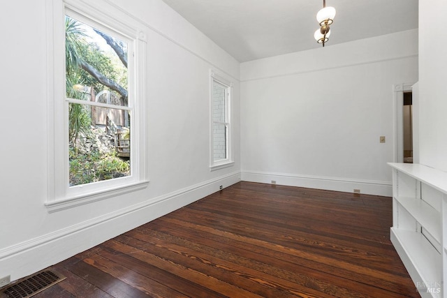 unfurnished room with dark hardwood / wood-style flooring