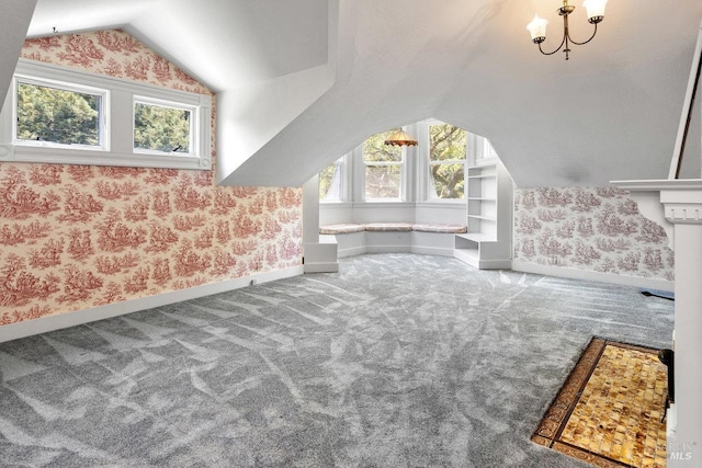 bonus room with lofted ceiling, plenty of natural light, an inviting chandelier, and carpet