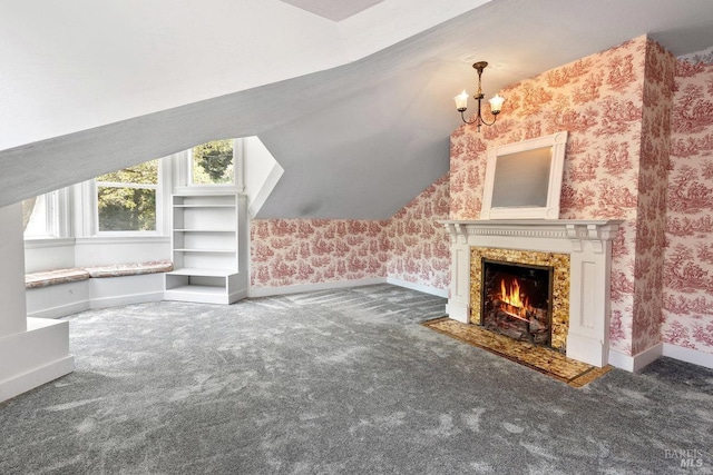 bonus room featuring a high end fireplace, vaulted ceiling, a chandelier, and dark colored carpet