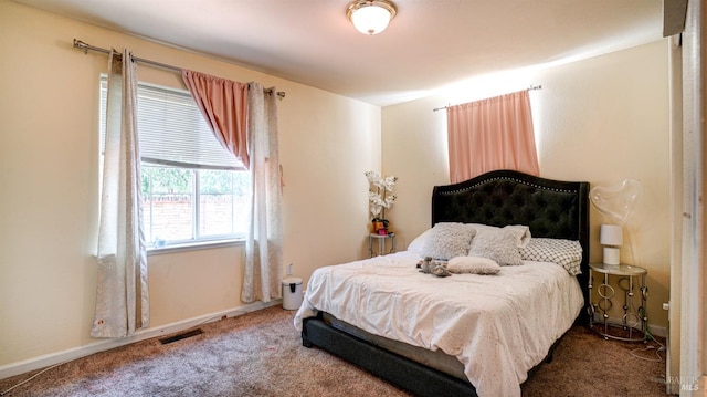 carpeted bedroom with visible vents and baseboards