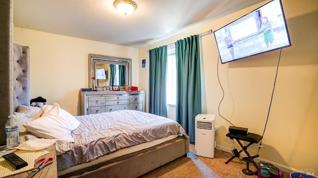 carpeted bedroom featuring baseboards