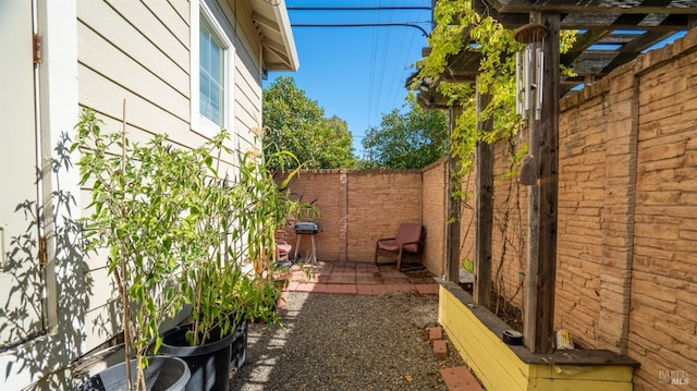 view of property exterior featuring a patio, a fenced backyard, and a pergola