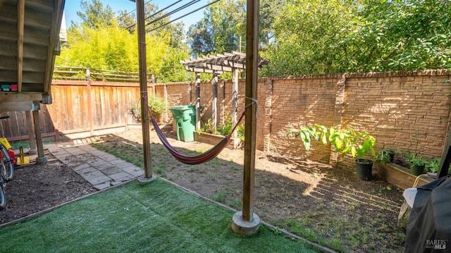 view of yard featuring a patio area, a fenced backyard, and a pergola