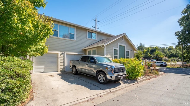 view of front facade featuring driveway and an attached garage