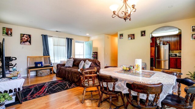 dining area featuring an inviting chandelier and hardwood / wood-style floors