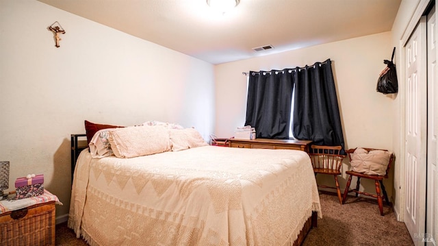 carpeted bedroom with a closet and visible vents