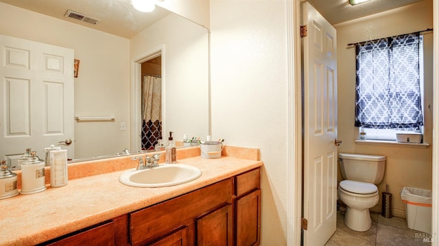 bathroom with tile patterned floors, toilet, and vanity