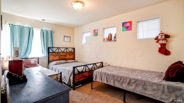 bedroom with visible vents and carpet flooring