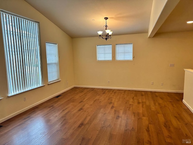 unfurnished room featuring lofted ceiling with beams, wood-type flooring, visible vents, and a notable chandelier