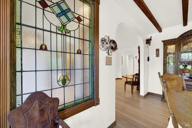 interior space featuring hardwood / wood-style floors and beamed ceiling