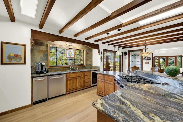 kitchen with pendant lighting, dishwasher, range, wine cooler, and light wood-type flooring