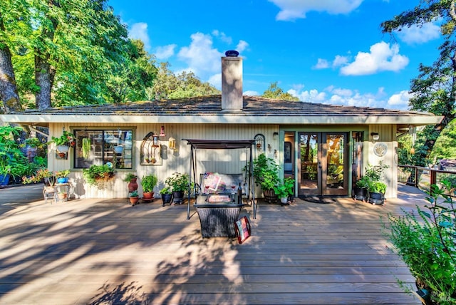 back of house with french doors and a deck