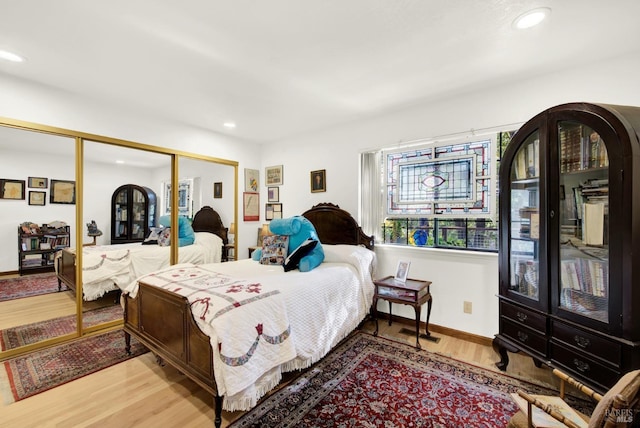 bedroom with hardwood / wood-style floors and a closet