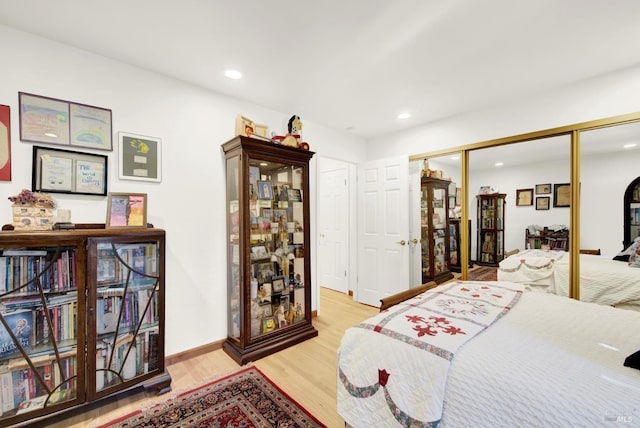 bedroom featuring a closet and light wood-type flooring