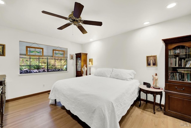 bedroom with ceiling fan and light hardwood / wood-style floors