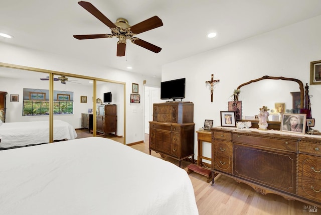 bedroom with ceiling fan, a closet, and light hardwood / wood-style flooring