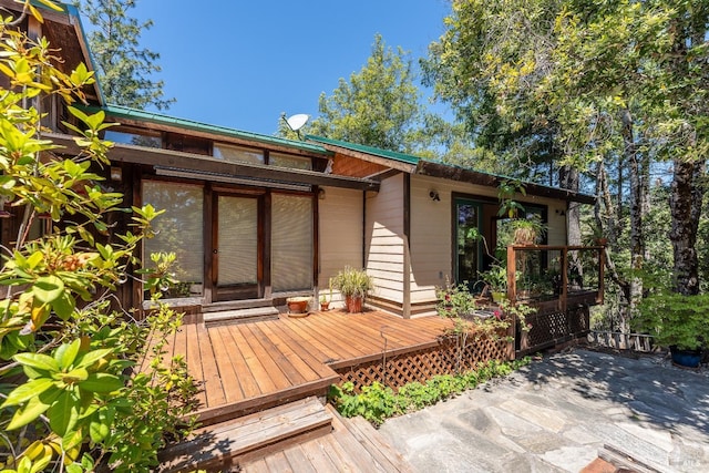 rear view of house with a wooden deck