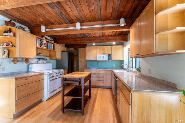 kitchen featuring open shelves, light countertops, light wood-style flooring, appliances with stainless steel finishes, and a sink