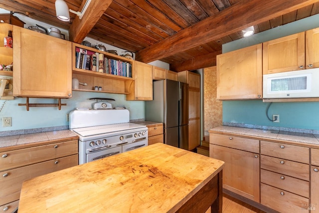 kitchen featuring white microwave, range with two ovens, wood counters, freestanding refrigerator, and open shelves