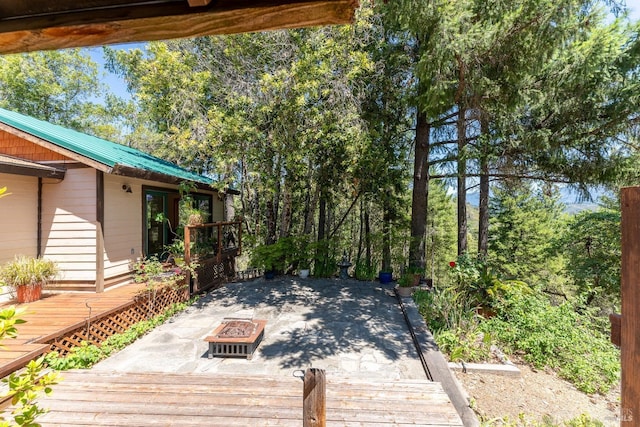 wooden terrace with a fire pit