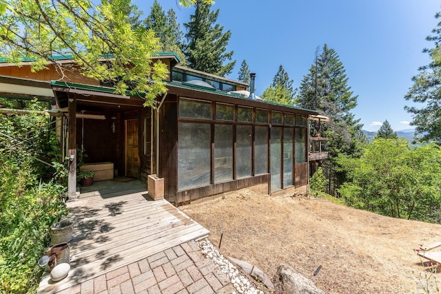 view of outdoor structure with a sunroom