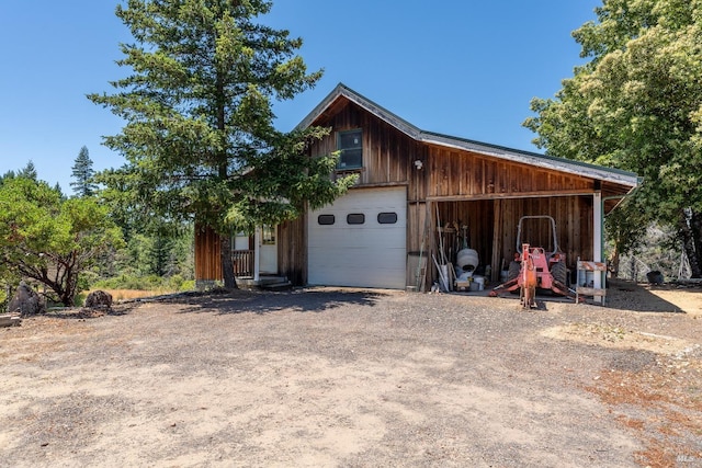 detached garage with dirt driveway