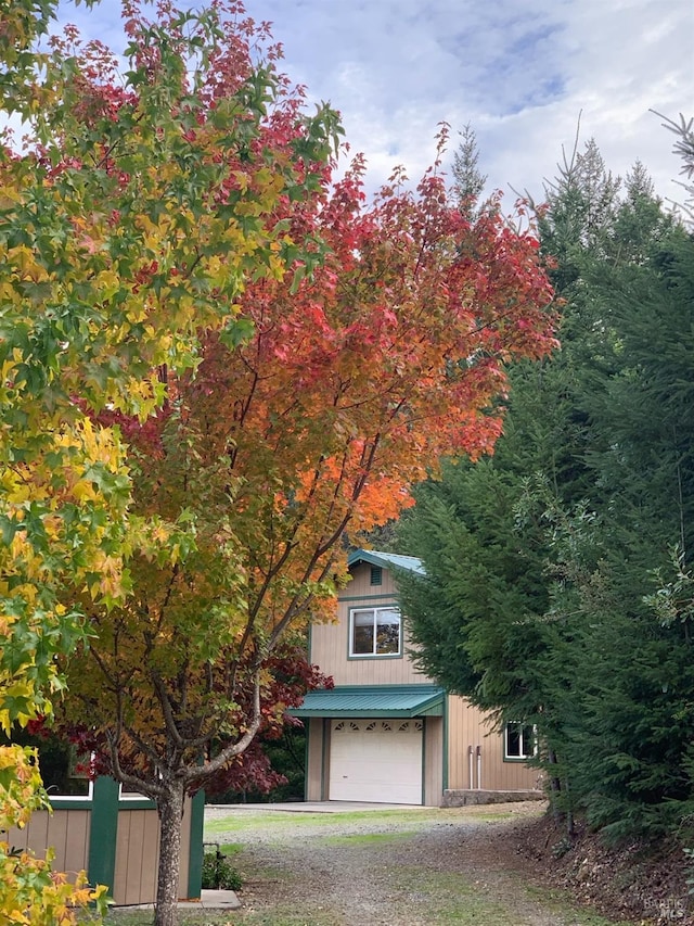 obstructed view of property with a garage