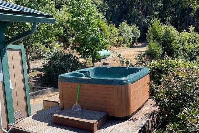 exterior space featuring a hot tub and a wooden deck