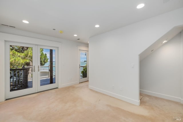 carpeted empty room featuring french doors