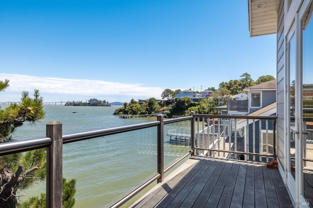 wooden terrace featuring a water view