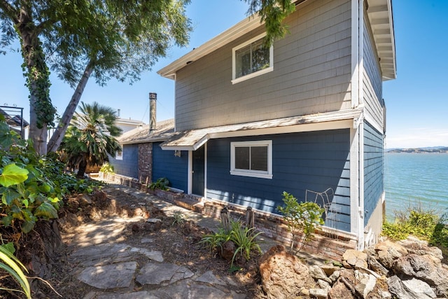 rear view of house featuring a water view