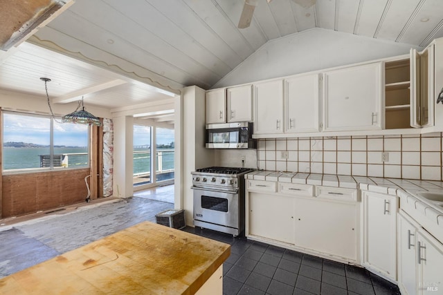 kitchen featuring pendant lighting, a water view, white cabinetry, and appliances with stainless steel finishes