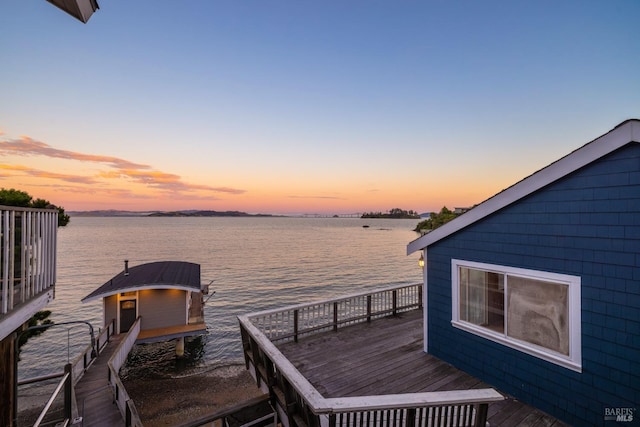 view of dock with a deck with water view