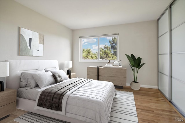 bedroom with light wood-style flooring and baseboards