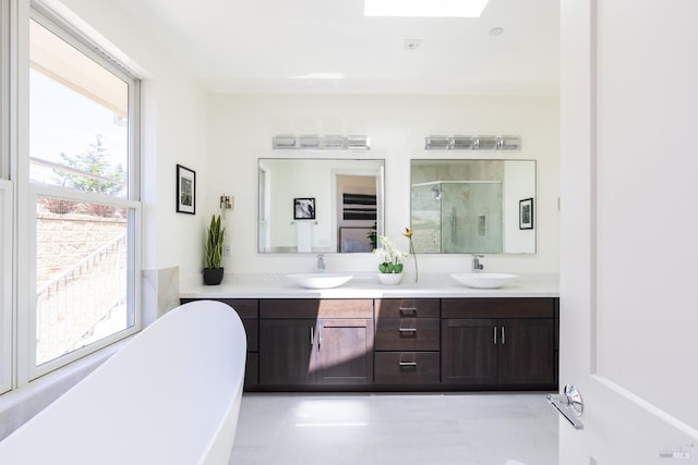 bathroom featuring a tub to relax in, tile patterned flooring, and double vanity