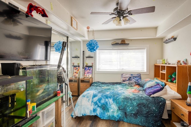 bedroom featuring hardwood / wood-style floors and ceiling fan