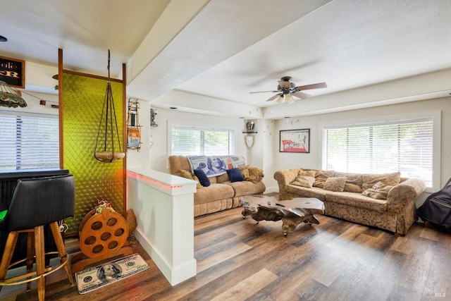 living room with hardwood / wood-style floors, ceiling fan, and a textured ceiling