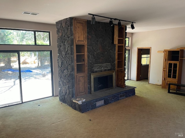2141 W Lincoln Ave, Napa, CA 94558 - unfurnished living room with track lighting, carpet, and a stone fireplace