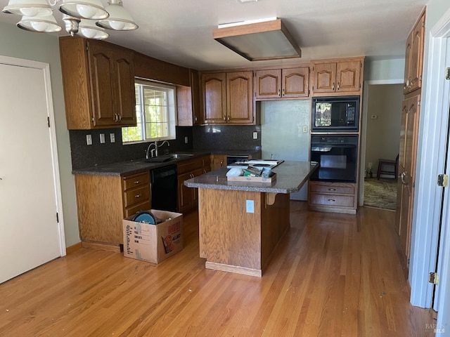 2141 W Lincoln Ave, Napa, CA 94558 - kitchen with black appliances, light wood-type flooring, backsplash, and a sink