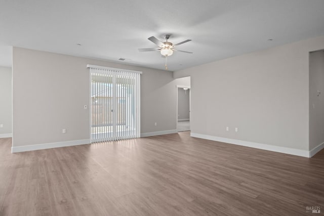 empty room featuring hardwood / wood-style floors and ceiling fan