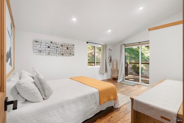 bedroom with vaulted ceiling, access to outside, and light hardwood / wood-style floors