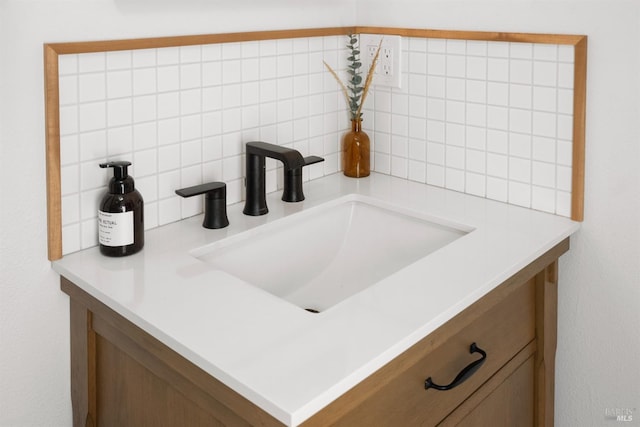 bathroom featuring sink and backsplash