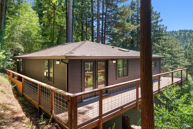 rear view of property featuring a wooden deck