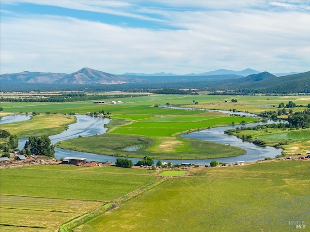 aerial view featuring a water and mountain view and a rural view